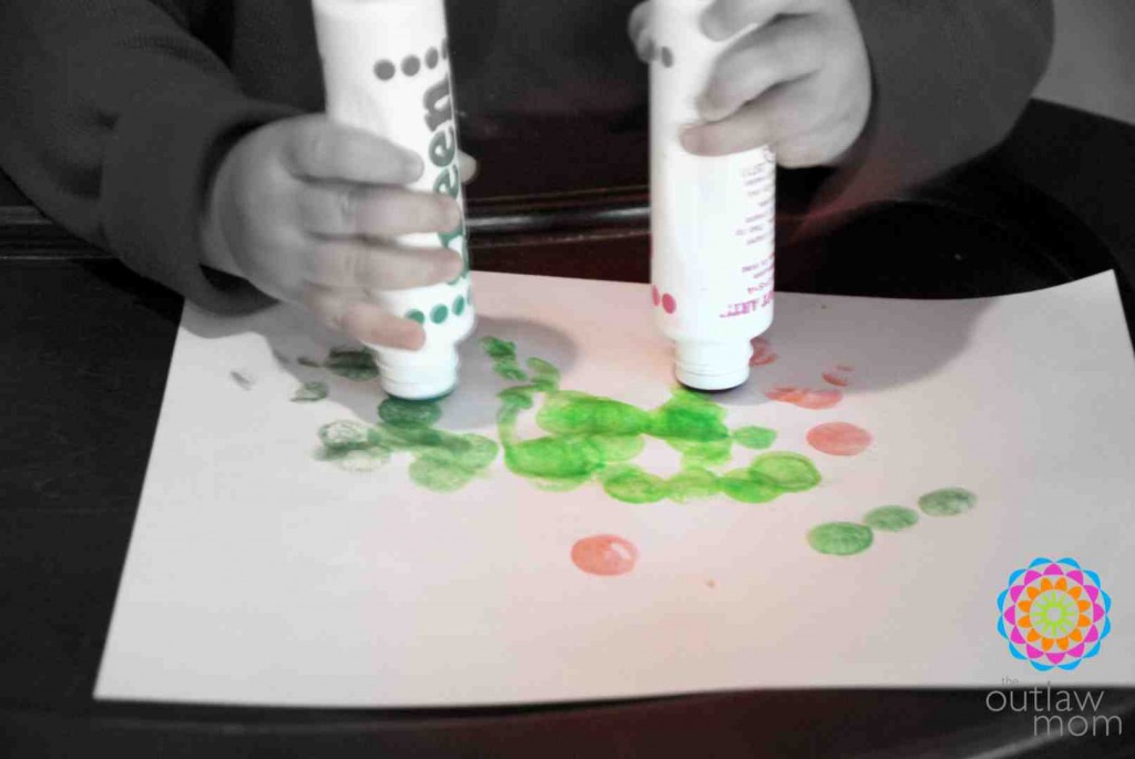 toddler learning to use dot markers