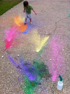 boy playing with splashes of powdered paint color