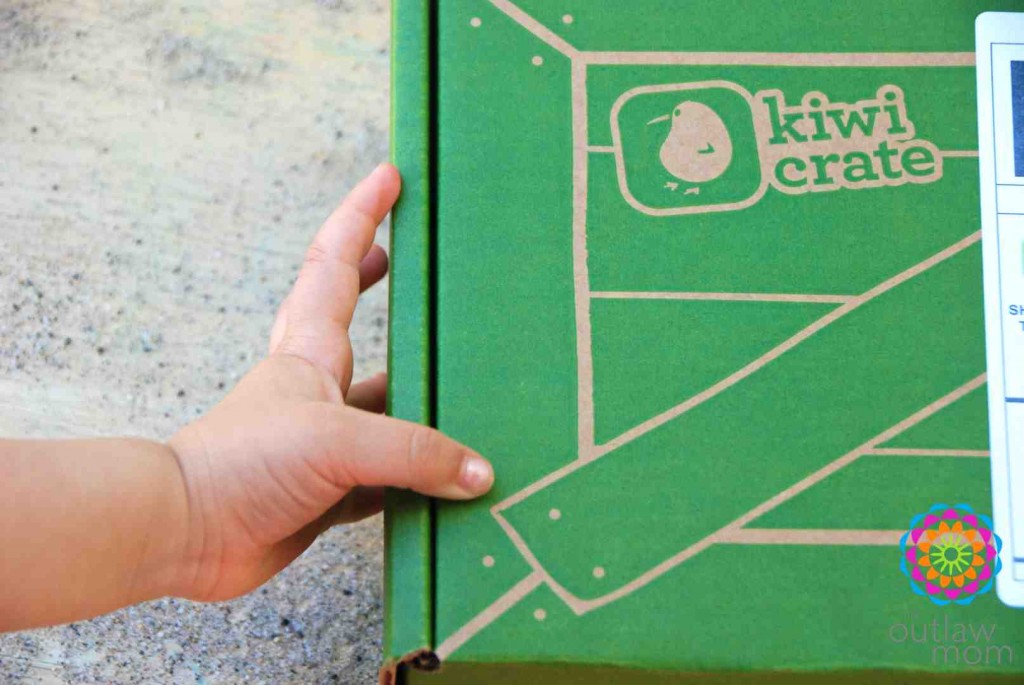 child holding kiwi crate box